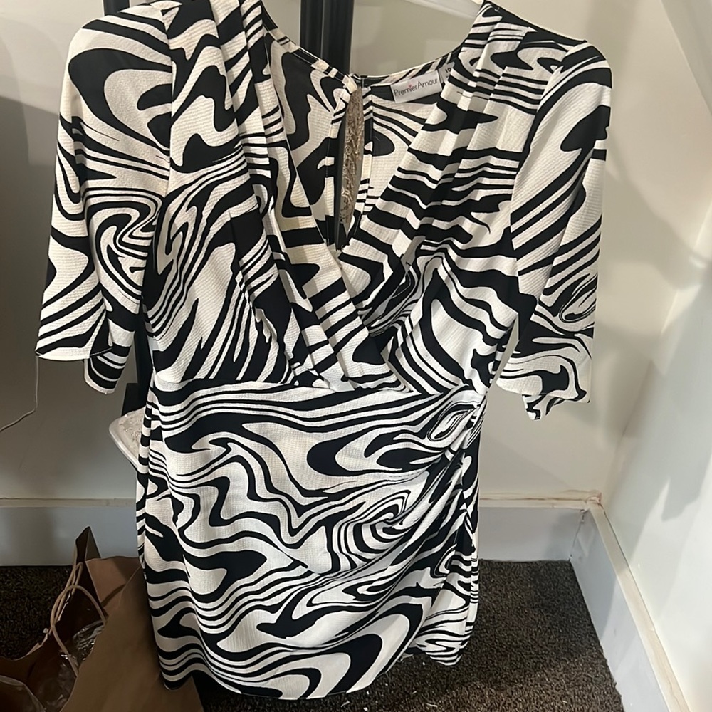 Pretty black and white dress with a low V neck and a small slit at the bottom.